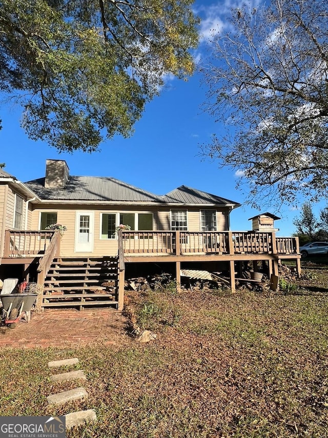 back of property featuring a deck