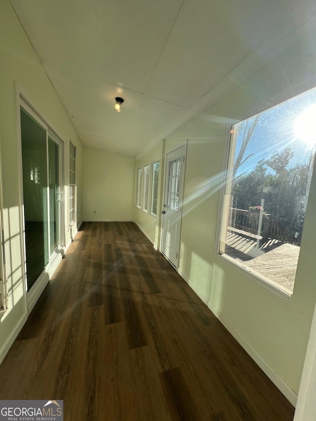 hallway with dark hardwood / wood-style flooring