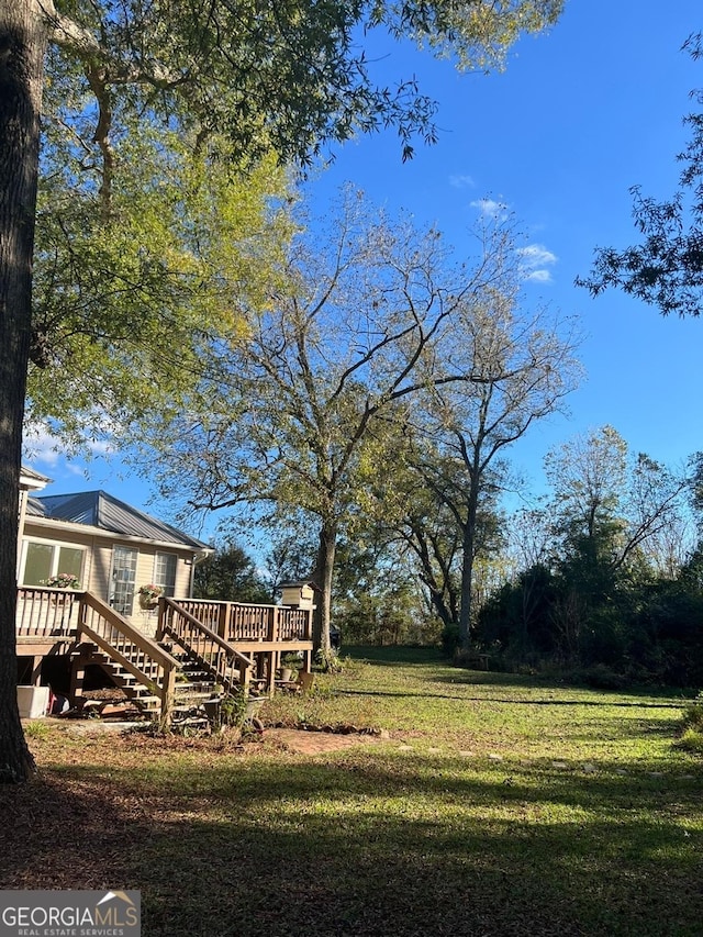 view of yard featuring a wooden deck