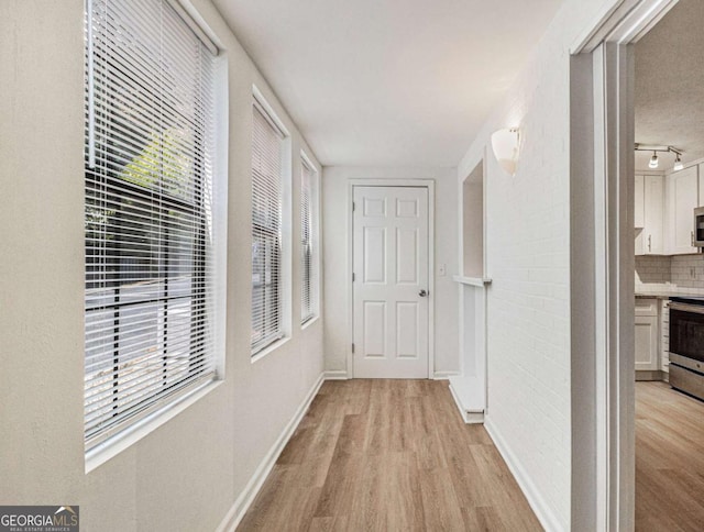 corridor featuring light wood-type flooring