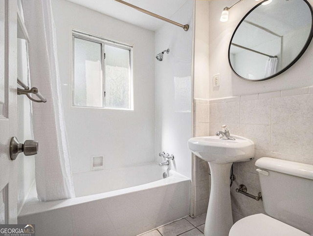 bathroom featuring tile patterned floors, toilet, tile walls, and shower / bath combination with curtain