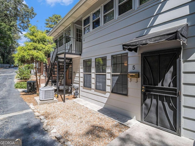 doorway to property featuring central air condition unit