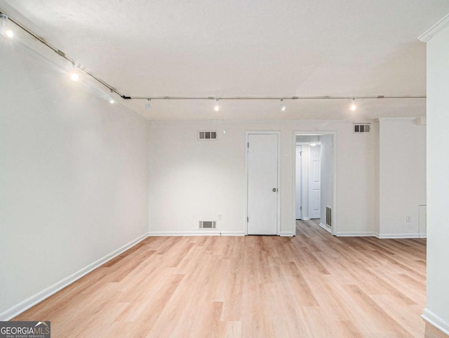 unfurnished room featuring light hardwood / wood-style floors and track lighting