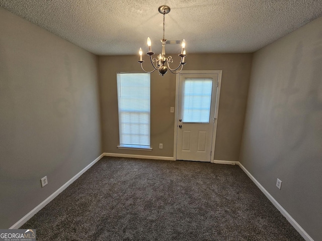 doorway featuring a notable chandelier, visible vents, baseboards, and dark colored carpet