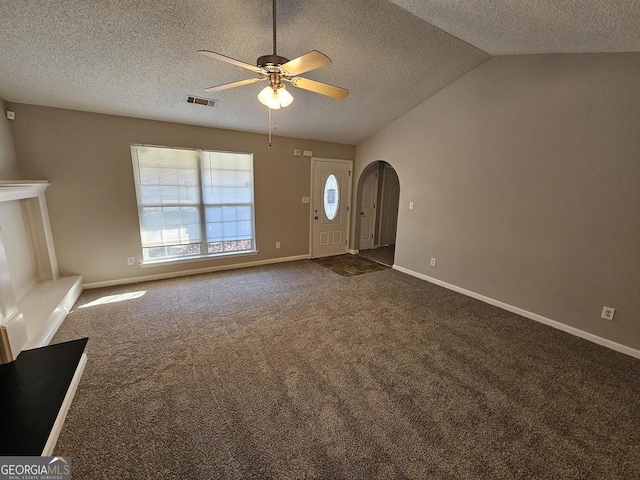 unfurnished living room with lofted ceiling, a ceiling fan, arched walkways, carpet flooring, and baseboards