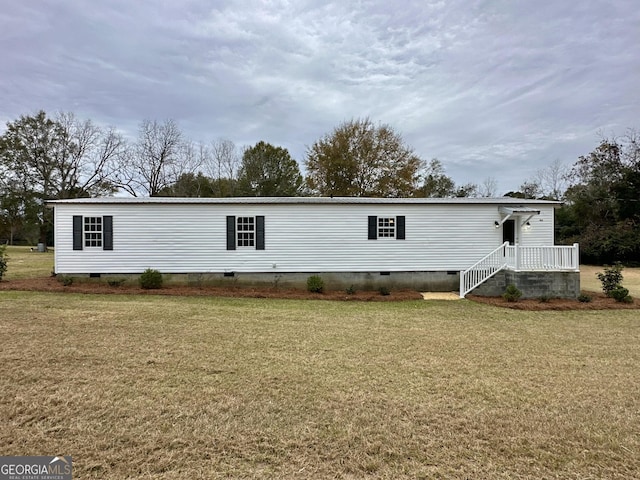 back of property featuring a lawn