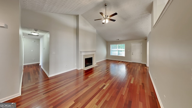 unfurnished living room featuring hardwood / wood-style floors, a textured ceiling, high vaulted ceiling, and ceiling fan