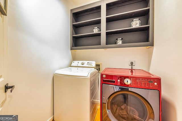 laundry area featuring washer and dryer and wood-type flooring