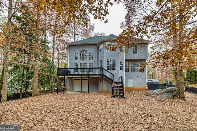 rear view of house featuring a wooden deck