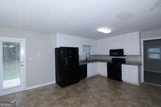 kitchen featuring sink, white cabinets, black appliances, and a textured ceiling