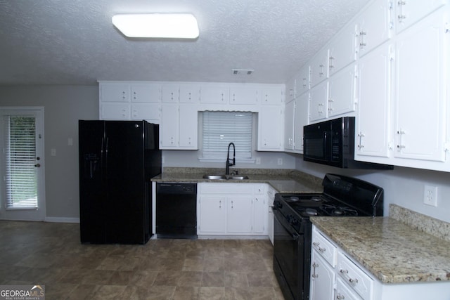 kitchen with black appliances, white cabinets, sink, and a textured ceiling