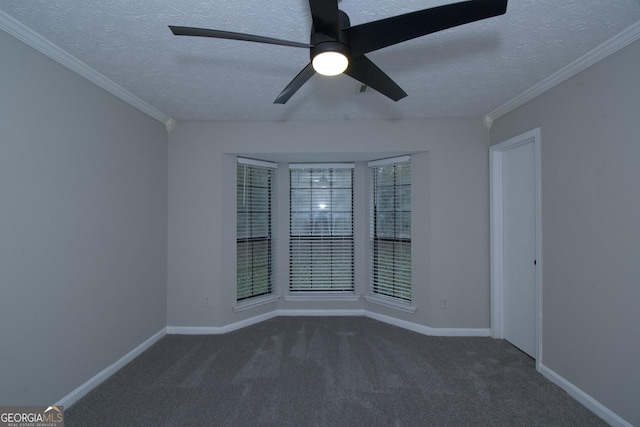 carpeted spare room with ceiling fan, ornamental molding, and a textured ceiling