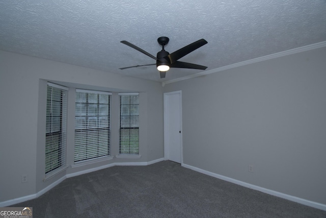 spare room with dark colored carpet, ceiling fan, and ornamental molding