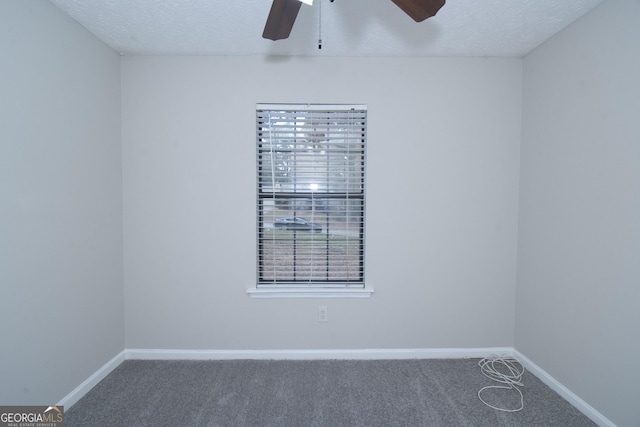 spare room featuring carpet flooring, a textured ceiling, and ceiling fan