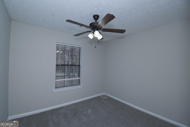 empty room with carpet, ceiling fan, and a textured ceiling