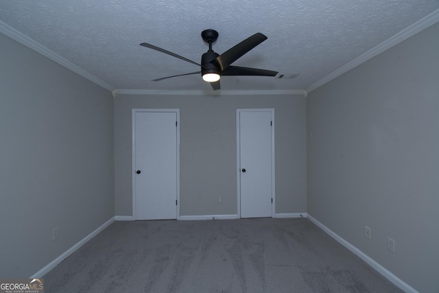 unfurnished bedroom featuring carpet, a textured ceiling, ceiling fan, crown molding, and a closet