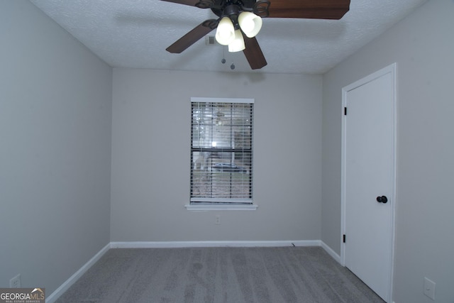 unfurnished room with ceiling fan, carpet floors, and a textured ceiling