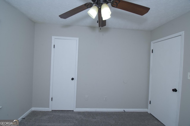 spare room featuring carpet flooring, ceiling fan, and a textured ceiling