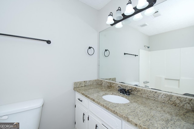 bathroom featuring vanity, toilet, a textured ceiling, and walk in shower