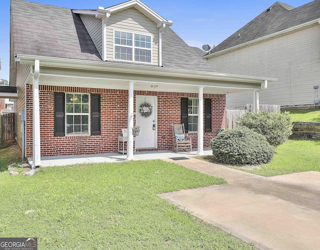 view of front of property featuring a front yard and a porch