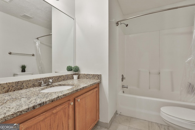 full bathroom with vanity, tile patterned floors, shower / bath combination with curtain, toilet, and a textured ceiling