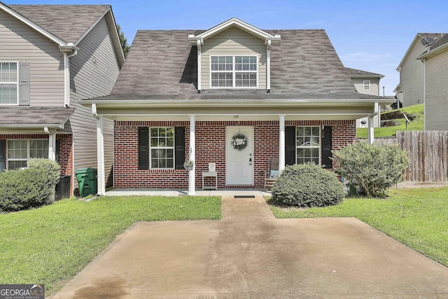 view of front of property featuring covered porch and a front yard