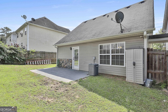 rear view of property with a yard and a patio