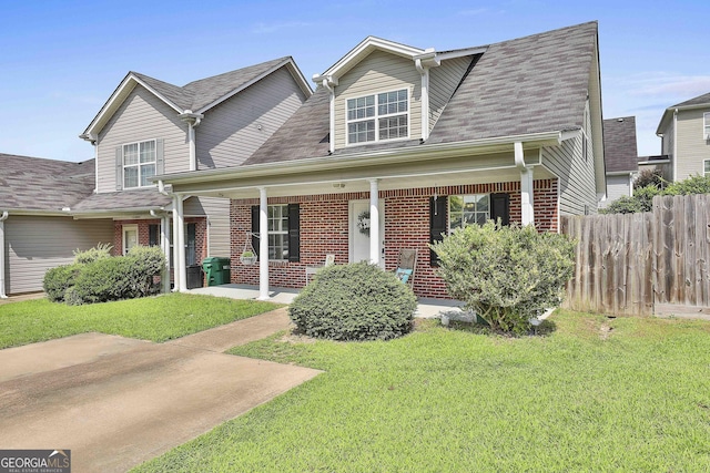 view of front facade featuring a front lawn and covered porch