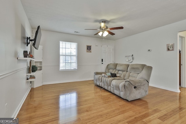 living room with ceiling fan and light wood-type flooring