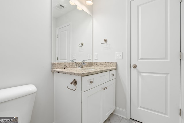 553 Lago Ct, Lagrange, GA 30241 - bathroom with visible vents, vanity, marble finish floor, toilet, and baseboards