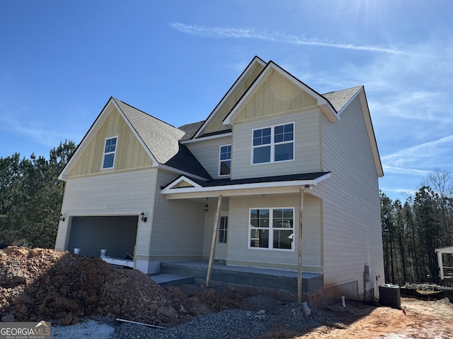 craftsman house featuring a garage, roof with shingles, cooling unit, a porch, and board and batten siding