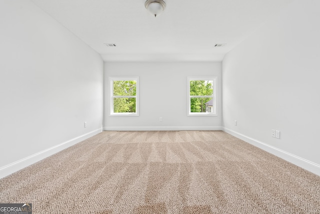 553 Lago Ct, Lagrange, GA 30241 - spare room featuring baseboards, a wealth of natural light, and light colored carpet