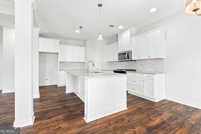 553 Lago Ct, Lagrange, GA 30241 - kitchen featuring visible vents, recessed lighting, stainless steel microwave, a sink, and range