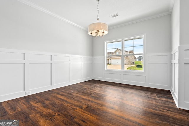 553 Lago Ct, Lagrange, GA 30241 - unfurnished dining area with crown molding, an inviting chandelier, a decorative wall, visible vents, and dark wood-style floors