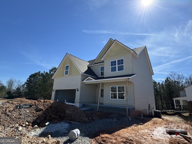 craftsman-style home featuring a garage, central AC, and board and batten siding