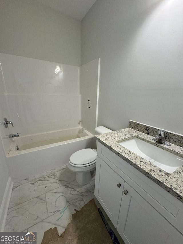 bathroom featuring toilet, marble finish floor, tub / shower combination, and vanity