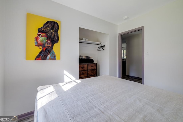 bedroom with wood-type flooring and a closet