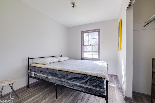 bedroom with hardwood / wood-style flooring