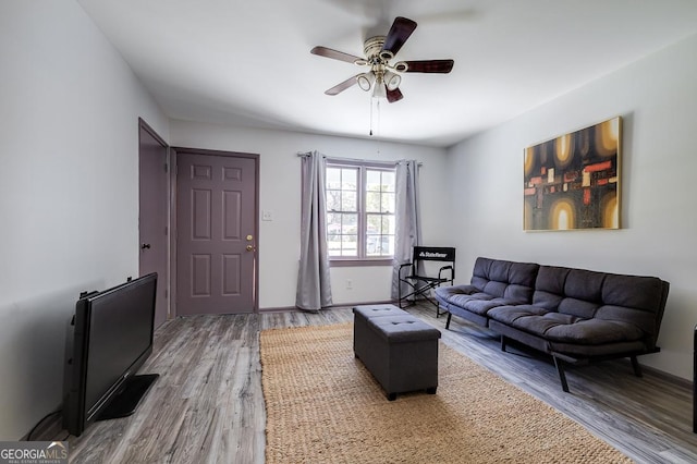 living room featuring hardwood / wood-style flooring and ceiling fan