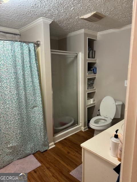 bathroom featuring a textured ceiling, wood-type flooring, and crown molding