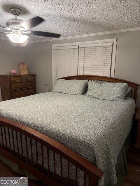 bedroom featuring ceiling fan, crown molding, and a textured ceiling