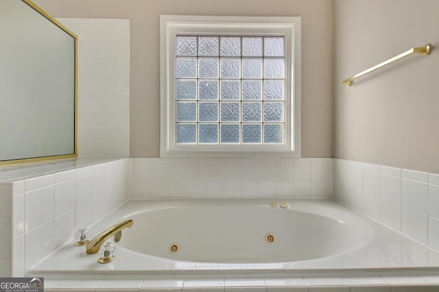 full bathroom with a jetted tub and plenty of natural light