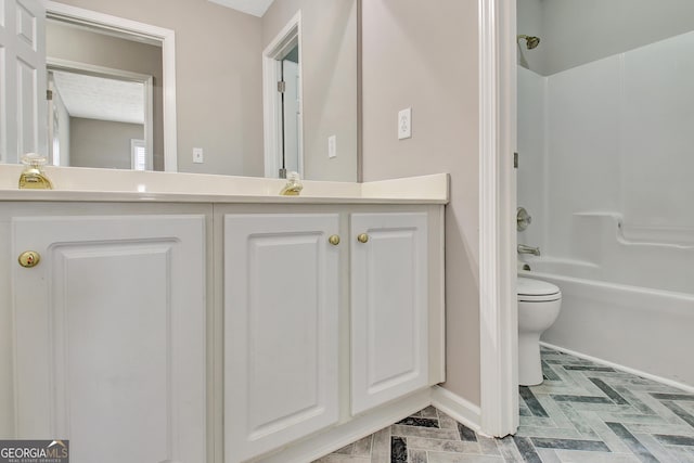 bathroom with toilet, vanity, baseboards, and shower / bathtub combination