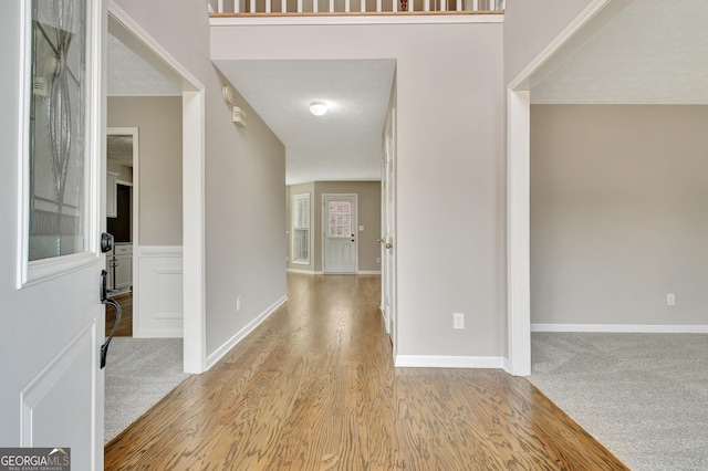 entrance foyer featuring baseboards and wood finished floors