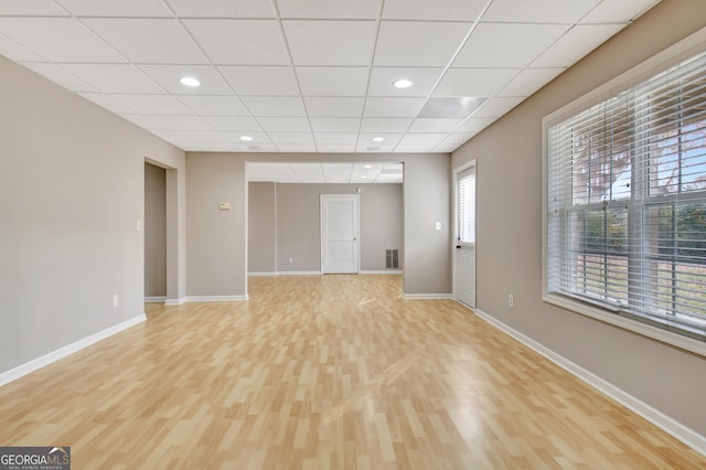 unfurnished room with light wood-type flooring, a paneled ceiling, baseboards, and recessed lighting