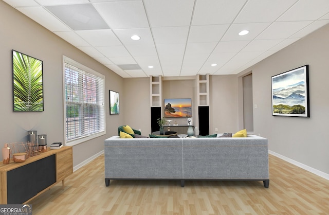 living area featuring recessed lighting, light wood-style flooring, and baseboards