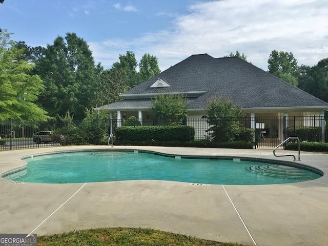 community pool featuring a patio and fence