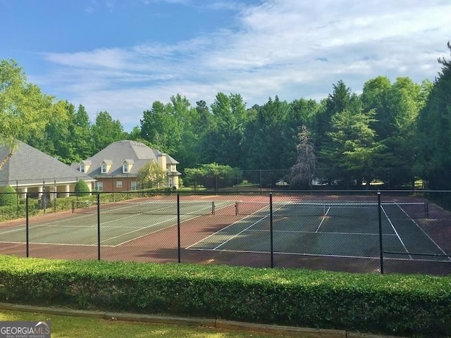 view of sport court featuring fence