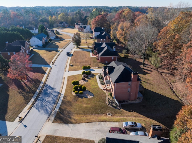 drone / aerial view featuring a forest view and a residential view