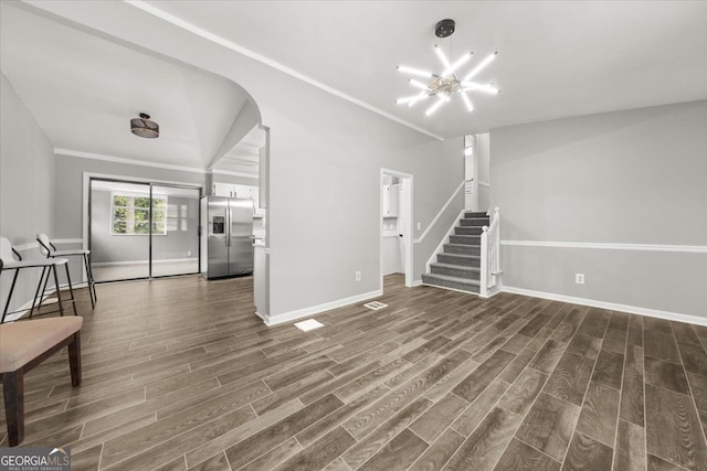 unfurnished living room with dark hardwood / wood-style flooring and ornamental molding